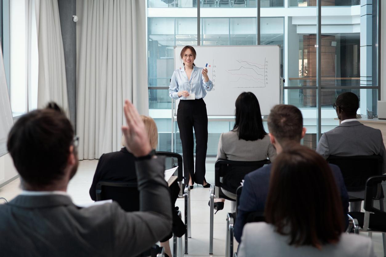 woman teaching in front of adult students